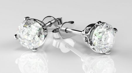 Earrings with diamond on a white background. Jewelry for women. 3d rendering